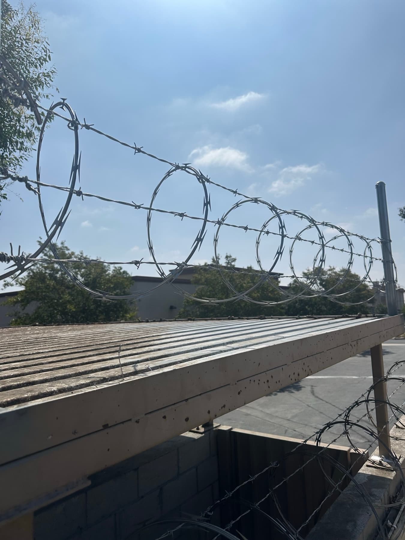 Razor wire security perimeter detail installed above a wall line