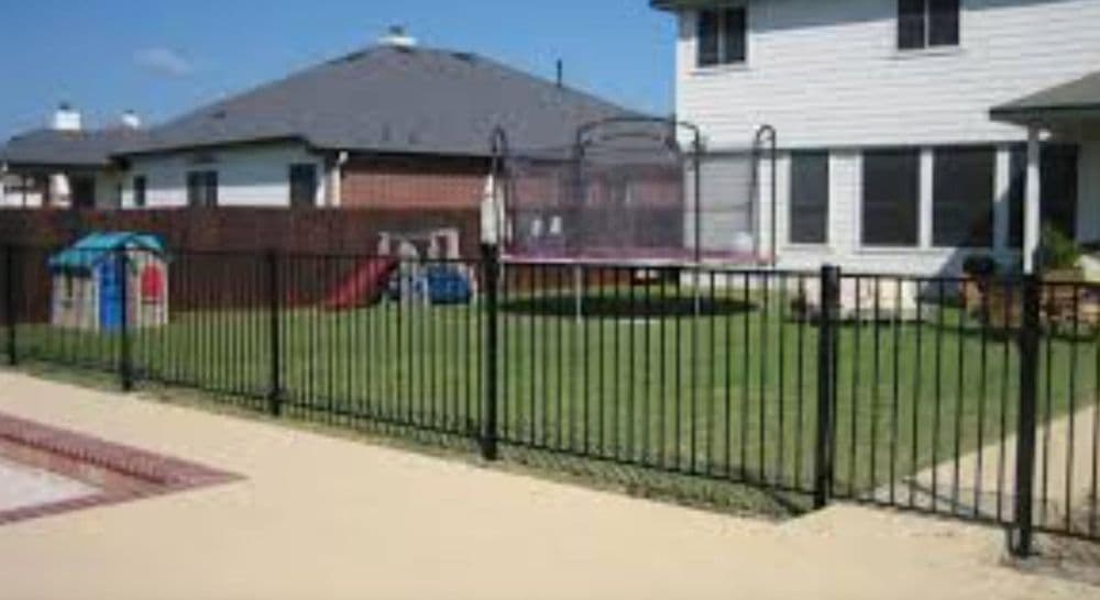Decorative wrought iron fence detail from an Empire Fence installation